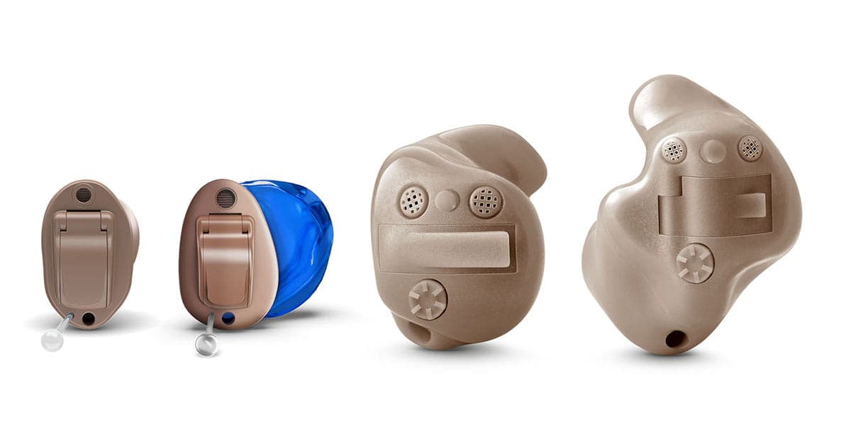 Different sizes of custom in-ear hearing aids, including discreet canal styles